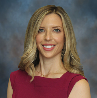 A professional headshot of dermatologist, Abby Russell against a light blue and orange background.